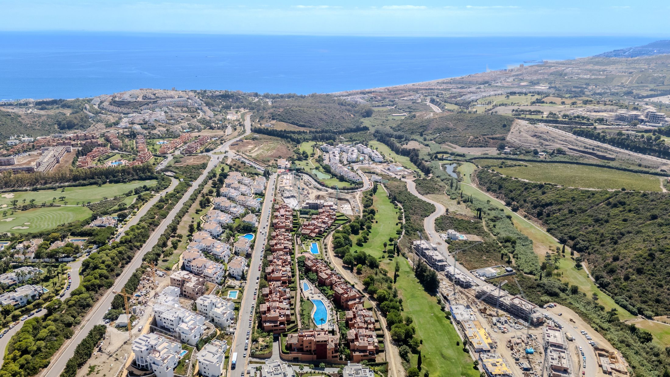 Drone panorama over Casares Golf Gardens and the golf course towards the Mediterranean coastline
